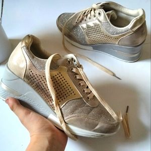 Super cute gold high heeled tennis shoe, not super hard to walk in!